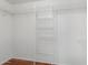 Walk-in closet featuring wire shelving and wood flooring at 1425 E Commerce Ave, Gilbert, AZ 85234