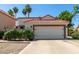 Charming home featuring a red tile roof, two-car garage, and drought-resistant landscaping at 1425 E Commerce Ave, Gilbert, AZ 85234