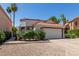 Charming home featuring a red tile roof, two-car garage, and drought-resistant landscaping at 1425 E Commerce Ave, Gilbert, AZ 85234