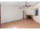 Inviting living room with a cozy brick fireplace and tile flooring at 1425 E Commerce Ave, Gilbert, AZ 85234