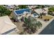 An aerial view of a two-story home shows solar panels on the roof, a two car garage and desert landscaping at 1631 N Avoca --, Mesa, AZ 85207