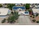 An aerial view of a two-story home shows solar panels on the roof, a two car garage and desert landscaping at 1631 N Avoca --, Mesa, AZ 85207