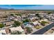 An aerial view of rooftops of homes in a suburban neighborhood. Many homes have solar panels at 1631 N Avoca --, Mesa, AZ 85207