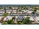 An aerial view shows a residential neighborhood with tile roofs and desert landscaping, with mountains in the distance at 1631 N Avoca --, Mesa, AZ 85207