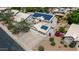 An aerial view of a two-story home shows solar panels on the roof, a two car garage and desert landscaping at 1631 N Avoca --, Mesa, AZ 85207
