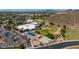 An aerial view shows a school with parking, playgrounds, sports fields and a desert landscape at 1631 N Avoca --, Mesa, AZ 85207