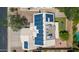 An aerial view shows solar panels, air conditioning units, and a backyard with grass, trees and a pool at 1631 N Avoca --, Mesa, AZ 85207