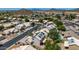 An aerial view shows a residential neighborhood with tile roofs and desert landscaping, with mountains in the distance at 1631 N Avoca --, Mesa, AZ 85207
