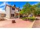 The home's backyard has a patio, turf, mature trees, climbing toy and desert landscaping at 1631 N Avoca --, Mesa, AZ 85207