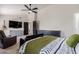 Cozy bedroom with a ceiling fan, a black daybed, dark wood furnishings and carpeted floor at 1631 N Avoca --, Mesa, AZ 85207
