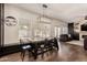 Dining area with large wood table, industrial chandelier, and a view to the outdoor patio at 1631 N Avoca --, Mesa, AZ 85207