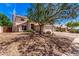 Charming single-Gathering home featuring a desert landscape, three-car garage, and solar panels under a bright, sunny sky at 1631 N Avoca --, Mesa, AZ 85207