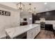 Modern kitchen features an oversized island, white marble countertops, and stainless appliances at 1631 N Avoca --, Mesa, AZ 85207