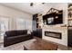 Comfortable living room with brick fireplace, mounted tv and view to the backyard at 1631 N Avoca --, Mesa, AZ 85207