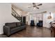 Bright living room features modern staircase, dark wood floors, and comfortable seating arrangement at 1631 N Avoca --, Mesa, AZ 85207