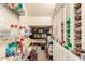 Walk-in pantry featuring wire and wood shelving, filled with an assortment of canned goods and household supplies at 1631 N Avoca --, Mesa, AZ 85207