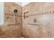 Tile shower with grab bars and built-in shelving provides safe and accessible showering at 1631 N Avoca --, Mesa, AZ 85207