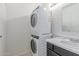 Bathroom with stacked washer and dryer, a mirror, and a vanity at 2220 W Dora St # 220, Mesa, AZ 85201