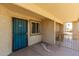 Welcoming entryway featuring a secure teal door and window, creating a bright, inviting entrance at 2220 W Dora St # 220, Mesa, AZ 85201