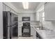 Modern kitchen with stainless steel appliances, marble countertops, and white cabinets at 2220 W Dora St # 220, Mesa, AZ 85201