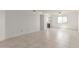 Bright living room with neutral tile flooring extending into kitchen, ample space, and natural light at 2220 W Dora St # 220, Mesa, AZ 85201