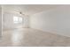 Spacious living room featuring neutral tile floors, a ceiling fan, and a window offering natural light at 2220 W Dora St # 220, Mesa, AZ 85201