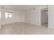 Bright living room with neutral tile flooring, a large window, and a classic white door at 2220 W Dora St # 220, Mesa, AZ 85201