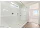 Modern bathroom featuring a glass shower enclosure, dual shower heads, and a bench at 25221 N 131St Dr, Peoria, AZ 85383