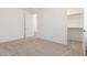Bright bedroom features plush carpeting, white walls, and walk-in closet for ample storage at 25221 N 131St Dr, Peoria, AZ 85383