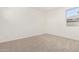 Bright bedroom featuring neutral carpet and a window overlooking the community at 25221 N 131St Dr, Peoria, AZ 85383