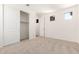 Spacious bedroom featuring sliding closet doors, carpet, and natural light at 25221 N 131St Dr, Peoria, AZ 85383