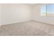 Bright bedroom featuring neutral carpet and natural light from a large window at 25221 N 131St Dr, Peoria, AZ 85383
