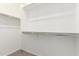Spacious walk-in closet features built-in shelving and ample hanging space for organization at 25221 N 131St Dr, Peoria, AZ 85383