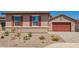 Charming single-story home featuring a two-car garage, brick accents, and a landscaped front yard at 25221 N 131St Dr, Peoria, AZ 85383