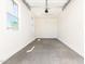 Clean and spacious garage with sealed concrete flooring and natural light, ready for use at 25221 N 131St Dr, Peoria, AZ 85383