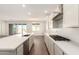 Bright kitchen with a large island, modern appliances, and an adjacent dining area at 25221 N 131St Dr, Peoria, AZ 85383
