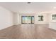Spacious living room with hardwood floors, bright windows, and access to the backyard at 25221 N 131St Dr, Peoria, AZ 85383