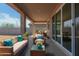Inviting covered patio with stylish furniture for relaxation and outdoor enjoyment at 25221 N 131St Dr, Peoria, AZ 85383