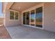 Relaxing back porch with a concrete floor, a ceiling light, and sliding glass doors to the interior at 25319 N 131St Dr, Peoria, AZ 85383