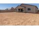 A large backyard with dirt, landscaping potential, and a covered porch, perfect for outdoor living at 25319 N 131St Dr, Peoria, AZ 85383
