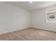 Light-filled bedroom with plush carpeting and a view from the window at 25319 N 131St Dr, Peoria, AZ 85383