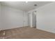 Light filled bedroom with carpet and multiple doors at 25319 N 131St Dr, Peoria, AZ 85383
