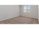 A simple bedroom, complete with carpeted floor and a window at 25319 N 131St Dr, Peoria, AZ 85383