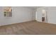 Carpeted bedroom with view to the en-suite bathroom at 25319 N 131St Dr, Peoria, AZ 85383
