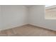 Bright bedroom with carpeted floors and a window providing natural light at 25319 N 131St Dr, Peoria, AZ 85383