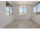 Charming dining area featuring tile floors, large windows, and a modern chandelier at 25319 N 131St Dr, Peoria, AZ 85383
