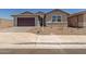 Charming single-Gathering home with a paver driveway, desert landscaping, and a warm, inviting facade at 25319 N 131St Dr, Peoria, AZ 85383