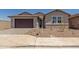 Charming single-story home boasts neutral stucco, desert landscaping, and a dark brown garage door at 25319 N 131St Dr, Peoria, AZ 85383