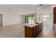 Open-concept kitchen with stainless steel sink, a large island, and brown cabinetry at 25319 N 131St Dr, Peoria, AZ 85383