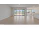 Bright living room with large sliding glass doors to the backyard, and tiled flooring at 25319 N 131St Dr, Peoria, AZ 85383